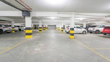 A multi-level parking garage with several cars parked.
