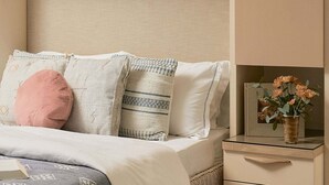 A bedroom with a bed, pillows, a bedside table, and a nightstand. - A Mesa Gem with Chic Coastal Vibes, Lush Outdoor Space, Detached Guest Studio & Hot Tub! (Santa Barbara)