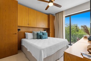 A bedroom with a bed, wooden headboard, ceiling fan, and a view through a large window. - Marina View Condo w/ Rooftop Pool, Gym & Beach Club – La Cruz, sleeps 6 (Bahia de Banderas)