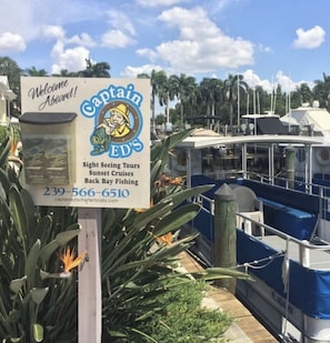 A signboard for Captain E.D.'s offering sightseeing tours, sunset cruises, and back bay fishing. - Awesome Private Beach Club & Pool w/ shuttle. Cozy 3-bed Condo in Bonita Bay (Bonita Springs)