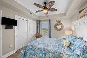 A bedroom with a bed, a ceiling fan, a TV, and a window with blinds. - Beachfront 2BR @ Palm Beach Resort • Sleeps 6  • Stunning Views (Orange Beach)