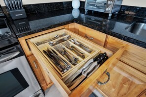 A kitchen with a drawer organizer containing various utensils. - Bright Coastal Retreat on Tybee's South End | Heated Pool Access (Tybee Island)