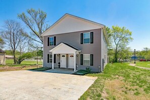 A two-story house with a front porch, a driveway, and a lawn. - Downtown Duo on Franklin (1010 Franklin St) (Clarksville)