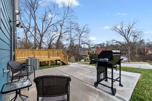 A patio with outdoor furniture, a grill, and a wooden deck. - Rebecca's Downtown Luxury Living (527 N 1st St) (Clarksville)