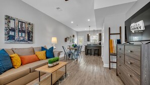 A modern living room with a sofa, coffee table, and a painting on the wall. - Tee Time Treasures in Sango (1625 Golf Club Ln, #602) (Clarksville)