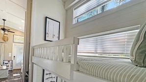 A bunk bed with a window, a ceiling fan, and a framed fish picture on the wall. - Cottage Between the Lakes ("In The Pines" at KY Lake) | 105 Pine Grove Lane, Dover, TN 37058 (Dover)
