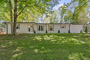 A single-story house with a brick exterior, a front porch, and a well-maintained lawn.