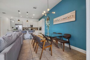 A modern kitchen with white cabinets, a stainless steel refrigerator, and a built-in microwave. - 4BR Family Townhome, pool, resort & Splash (Davenport)