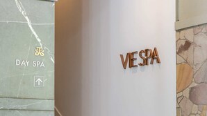 A reception area with a 'VESPA' sign, a 'DAY SPA' sign, and a staircase leading to an upper level. - SeaEden @ The Temple Studio Spa Apartment (Craiglie)