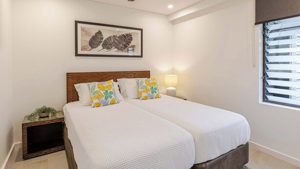 A bedroom with a bed, a nightstand, a lamp, a ceiling fan, and a window with blinds. - SeaEden @ The Temple 3 Bedroom with Private Pool (Craiglie)