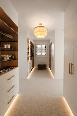 A hallway with a central light fixture, wooden shelving, and a bench. - The Sanctuary by Aryve (Mermaid Waters)