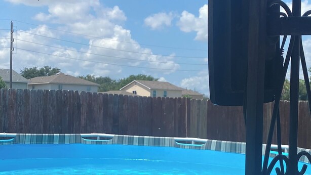 A swimming pool with a wooden fence in the background. - 3-bedroom flat in Cypress ,second floor with independent entrance  (Cypress)