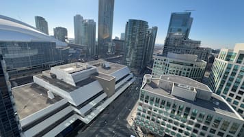 A modern urban skyline with high-rise buildings, including a distinctive curved structure and a building with a large glass facade.