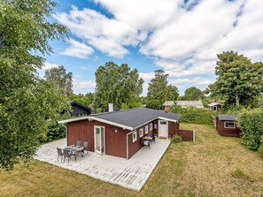 A single-story wooden cabin with a deck, a small attached building, and a grassy yard. - "Ulli" - 350m from the sea by Interhome (Grenaa)