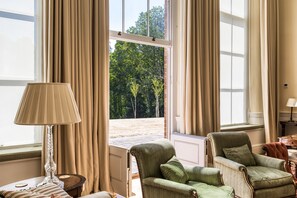 A room with a view of trees through a window, a lamp, and two armchairs. - The Orangery -  Bridgnorth , Shropshire (Bridgnorth)