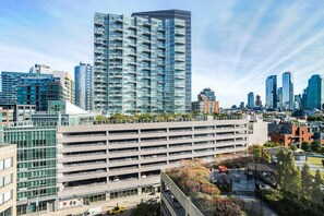 A multi-story parking garage with a modern design, surrounded by high-rise buildings and a clear sky. - Blueground | Long Island City, pool, nr Gantry Plaza (New York)