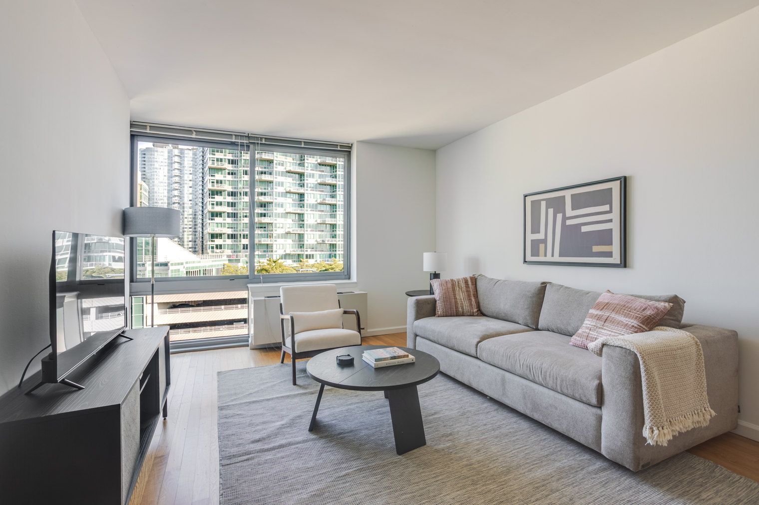 A modern living room with a sofa, coffee table, and a television.
