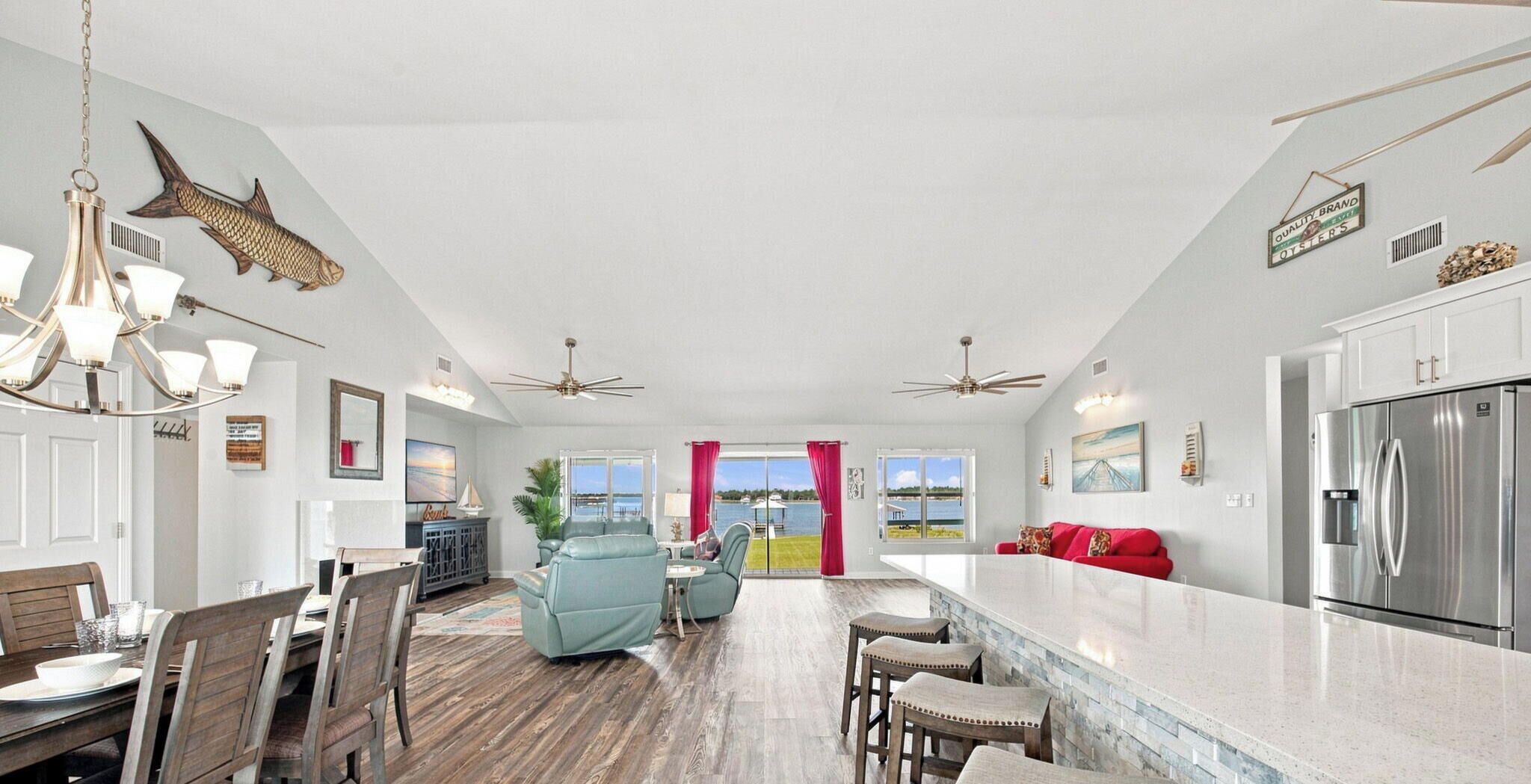 A spacious kitchen with a large island, modern appliances, and a view to the outside.