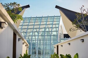 A modern building with a glass facade and a geometric design.