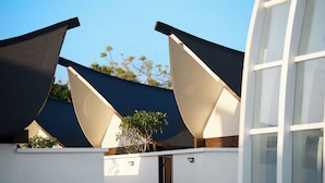 A modern building with a unique roof design featuring multiple angled sections.