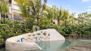Una piscina de borde curvo con un mural de criaturas marinas.