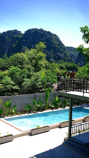 A swimming pool with a view of a mountainous landscape.