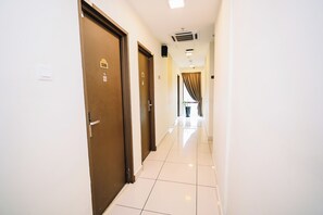 A hotel corridor with doors numbered 538 and 537, a ceiling-mounted air vent, and a view into a room with a window and curtains. - Swing & Pillows - Dataran Merdeka KL (Kuala Lumpur)