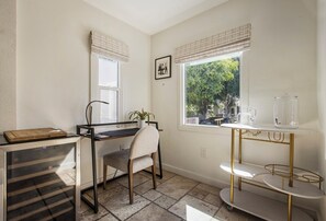 A compact home office with a desk, chair, and a window with blinds. - Serene LA 2BR Retreat with BBQ & Outdoor Lounge (Los Angeles)