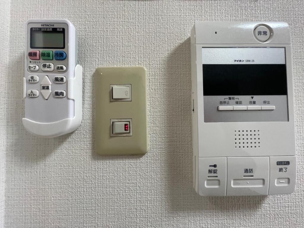 A control panel with a keypad, a light switch, and a display screen.