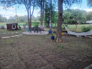 A backyard with a hammock, a bench, and potted plants. - Peaceful rv get away on the river (Smithville)