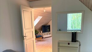 A bedroom with a bed, a window, and a view of a living area. - Scenic home in Virklund (Virklund)