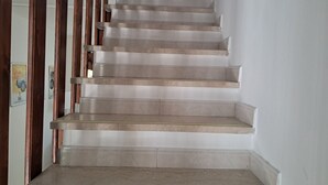 A staircase with a handrail and a landing.