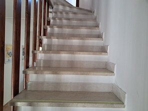 A staircase with a handrail and a landing.