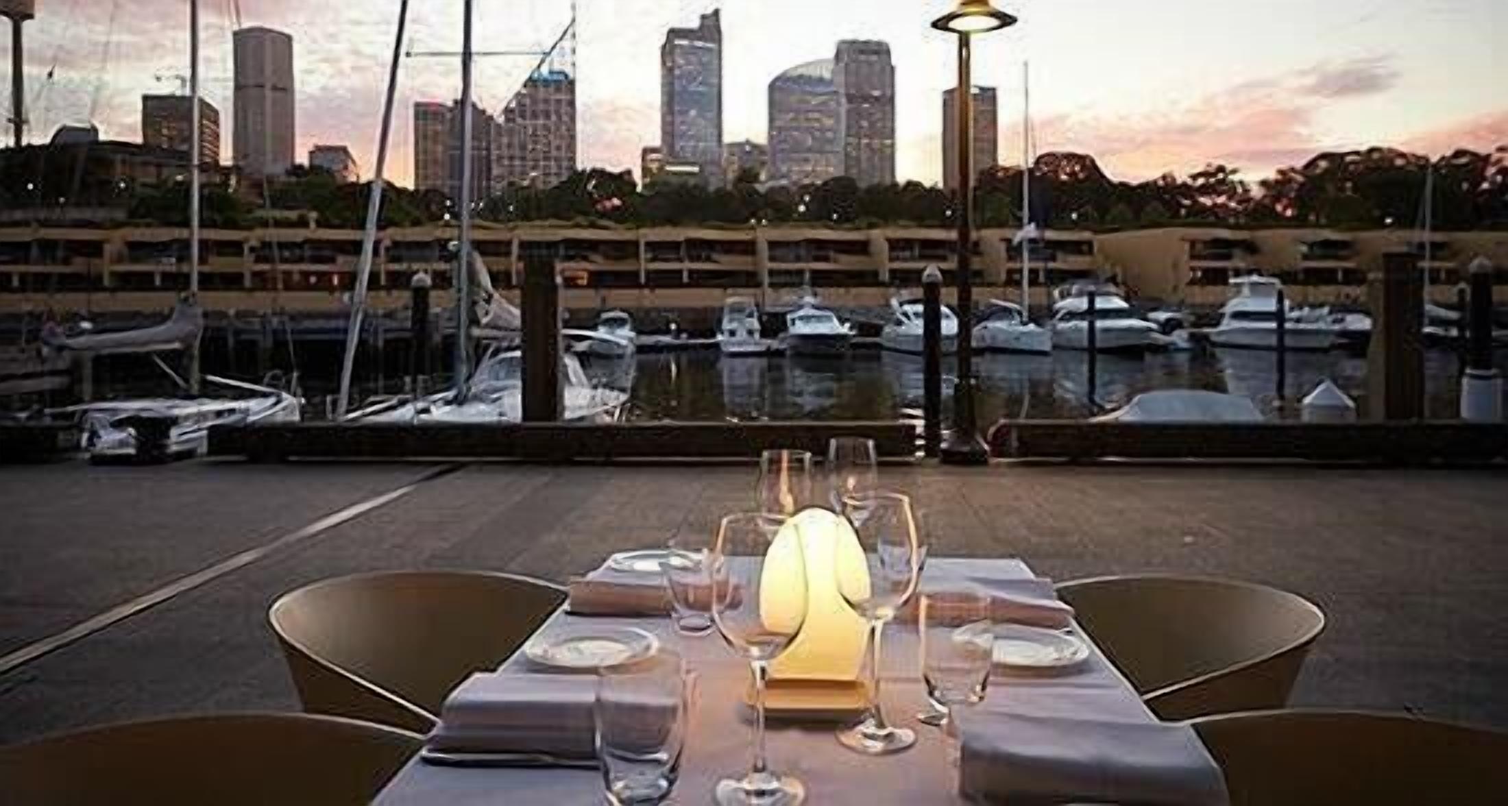 A table set for dining with a city skyline view in the background.