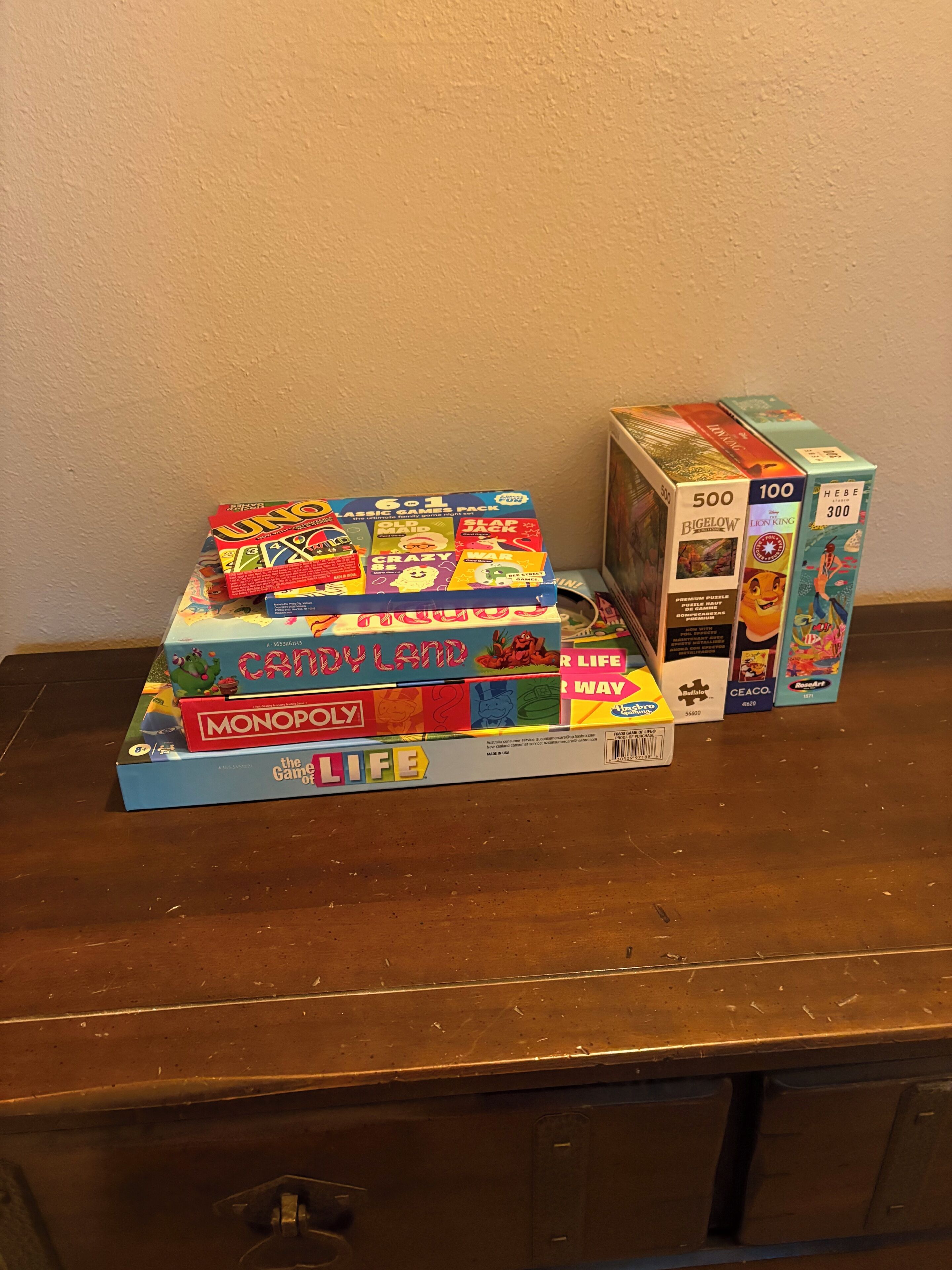 A collection of board games on a wooden surface.