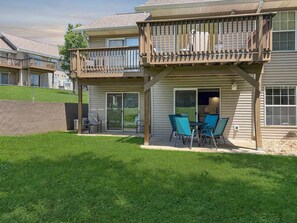 A residential building with a balcony, sliding glass doors, and outdoor seating. - No stairs, clean peaceful secluded, close to strip (Branson)