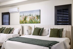 A hotel room with two beds, a painting, and two windows with blinds. - Luxury 7BR Getaway/10 Beds/Near Victoria Gardens (Rancho Cucamonga)