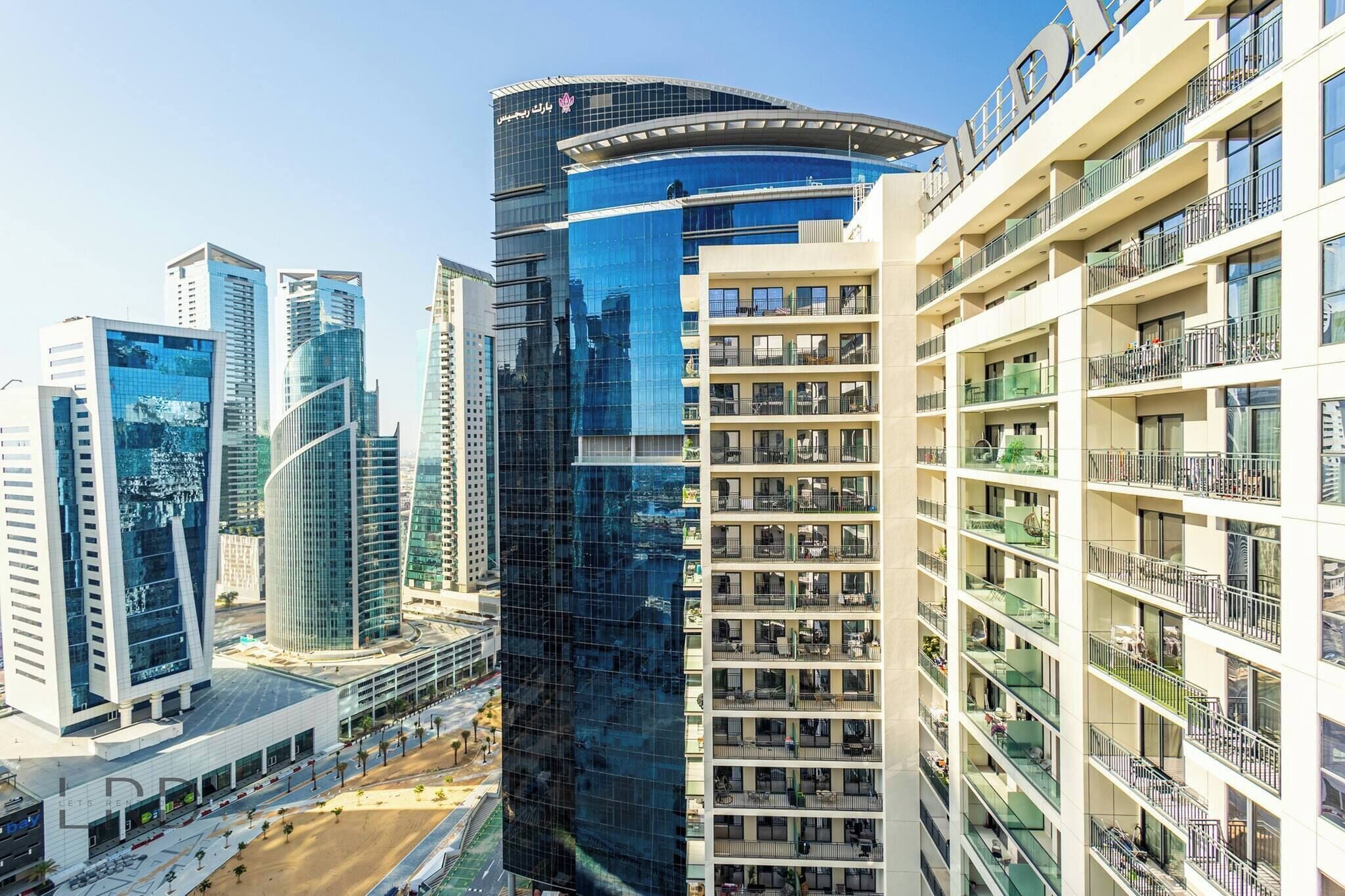 A high-rise building with multiple balconies and a modern architectural design.