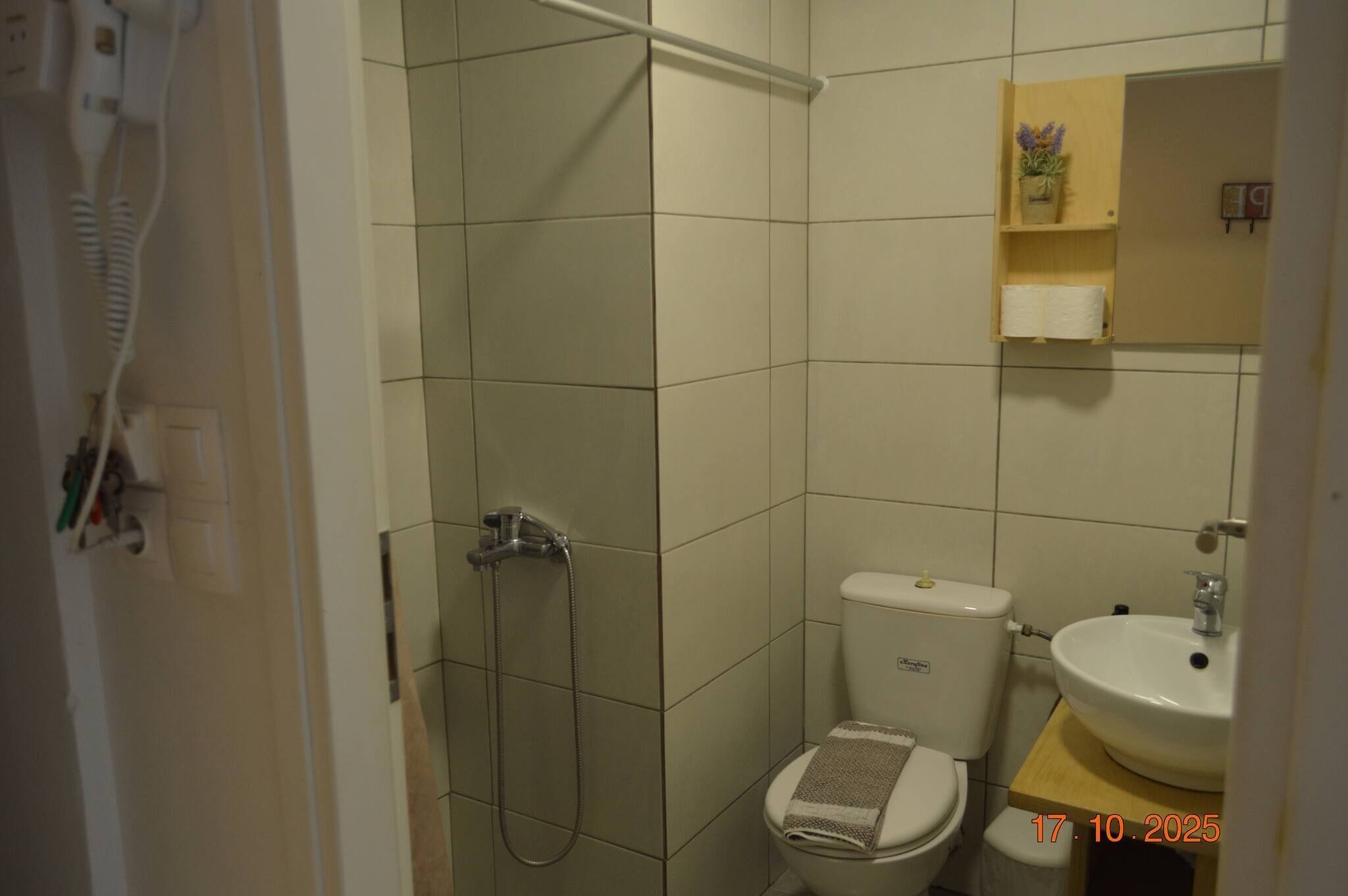 A bathroom with a shower, toilet, and sink.