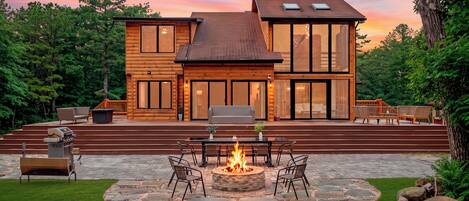 Outdoor fun spans the expansive deck and stone patio, with lounge seating and plenty of room to gather.