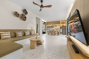 A modern living room with a sofa, coffee table, and a TV.
