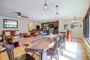 A modern kitchen with dark cabinetry, a central island, and pendant lighting. - 1 Mi to Mount Snow! Classic Chalet w/ Hot Tub (West Dover)