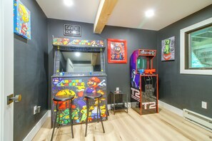 A room with arcade games, including a Mario-themed machine and a Tetris machine, and a Game Room sign on the wall. - 1 Mi to Mount Snow! Classic Chalet w/ Hot Tub (West Dover)