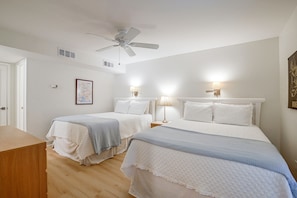 A hotel room with two beds, a ceiling fan, wall-mounted lamps, and a framed map on the wall. - Pawleys Island Golf + Beach Getaway w/ Pool Access (Pawleys Island)