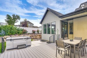 A patio with a grill, outdoor table, and chairs. - Hot Tub, Group Hub, Close to Deer Valley (Heber City)