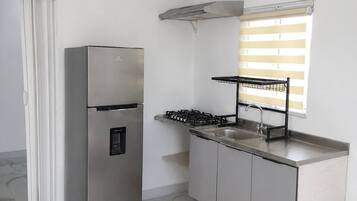 Coffee/tea maker, fridge, cookware/dishes/utensils