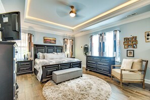 A bedroom with a large bed, a dresser, a chair, and a television. - Sun, Fun & Soak: Stunning Myrtle Beach Escape! (Myrtle Beach)