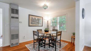 A dining area with a round table, four chairs, a patterned rug, a ceiling light fixture, and a framed artwork on the wall. - Walk to Dtwn Corvallis: Home Near OSU & Riverwalk (Corvallis)