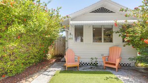 A house with a front yard, two wooden chairs, and a small lawn. - Walk to Dtwn! Home 2 Mi to Lake Worth Beach Park (Lake Worth Beach)