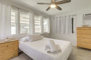 A bedroom with a bed, a nightstand, a dresser, and a ceiling fan. - Walk to Dtwn! Home 2 Mi to Lake Worth Beach Park (Lake Worth Beach)